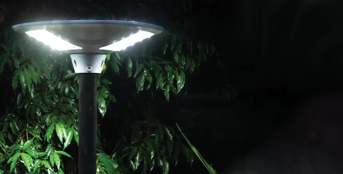 bright solar light mounted on pole illuminating entire garden