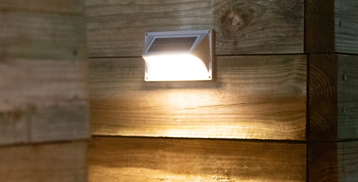 small solar light mounted on outside wall of garage in Brisbane