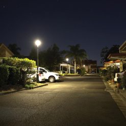 Bright solar light shining on car parking spaces at night in Brisbane