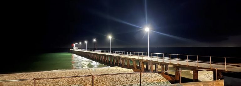 Long pier lit up by a row of powerful solar lights
