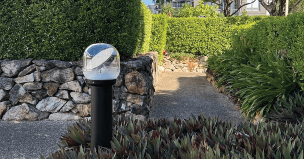 Solar bollard light in flower bed at an apartment block in Brisbane